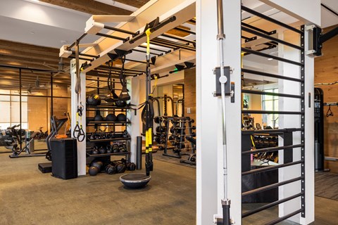 Strength training area within the property fitness center, equipped with a comprehensive free weight setup.