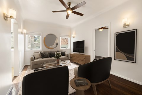 A living room with a black chair and a grey couch.