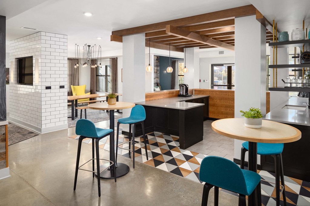 a kitchen and dining area with tables and chairs