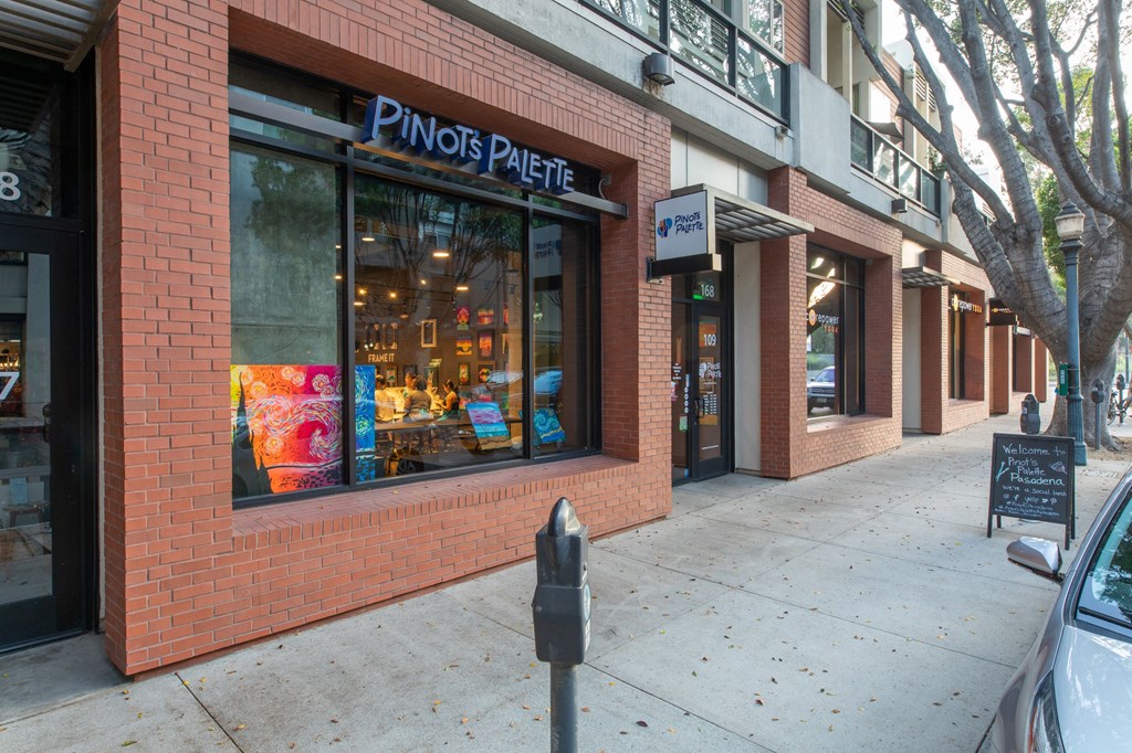 a brick building with a window and a parking meter