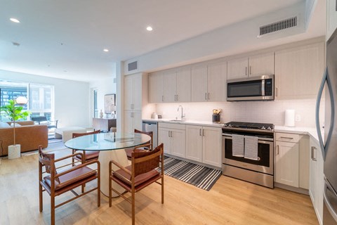 a kitchen and dining room with a table and chairs