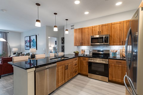 A modern kitchen with wooden cabinets and stainless steel appliances.