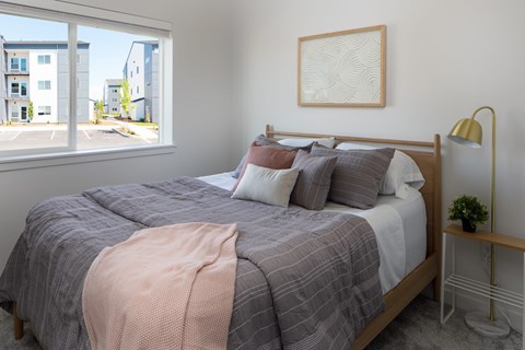 Bedroom with a bed, pillows, a blanket, a lamp, and a framed picture on the wall at The Arvon, Vancouver,98662