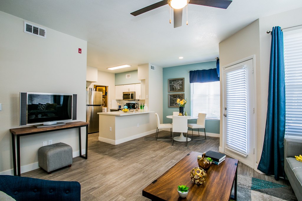 A living room with a television and a dining table.