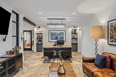 A modern living room with a brown leather couch and a wooden coffee table.