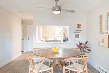 A dining room with a table and chairs.