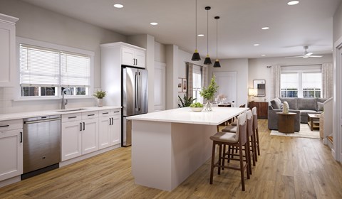 A modern kitchen with a center island and stainless steel appliances.