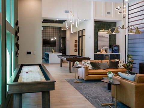 A room with a pool table and a couch.