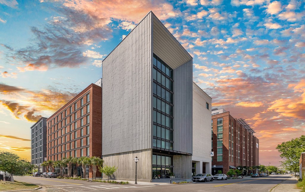 A modern building with a large glass window is the main focus of the image.