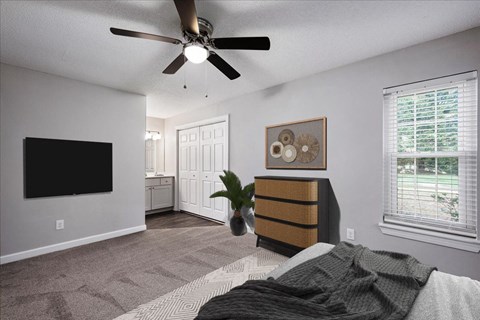a bedroom with a bed and a ceiling fan