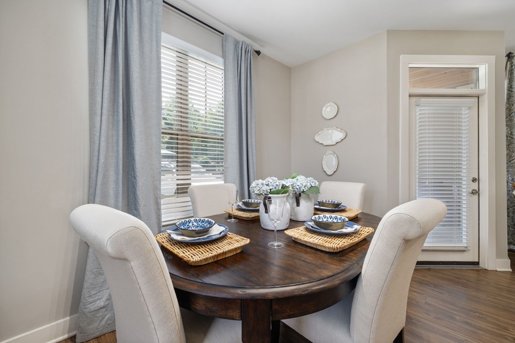 A dining room with a table set for two.