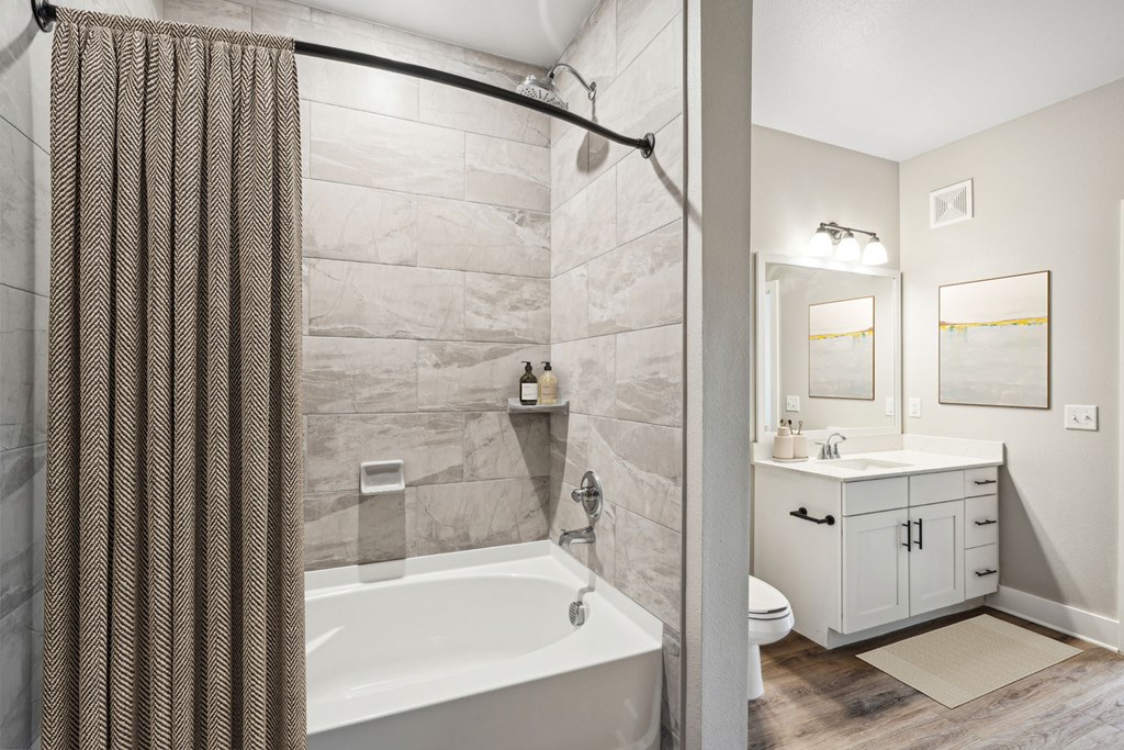 A2 A bathroom with a tub, sink, and shower.