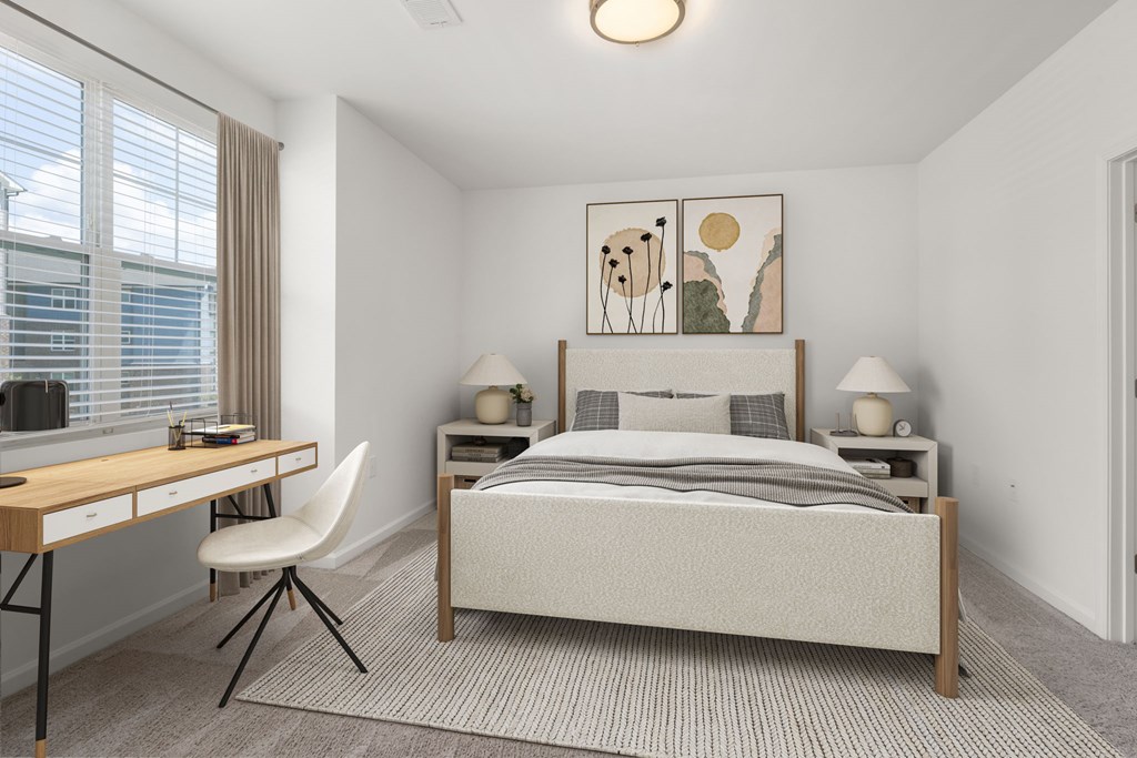 A bedroom with a bed, desk, and chair.