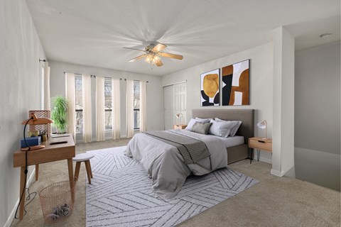 a bedroom with a bed and a ceiling fan