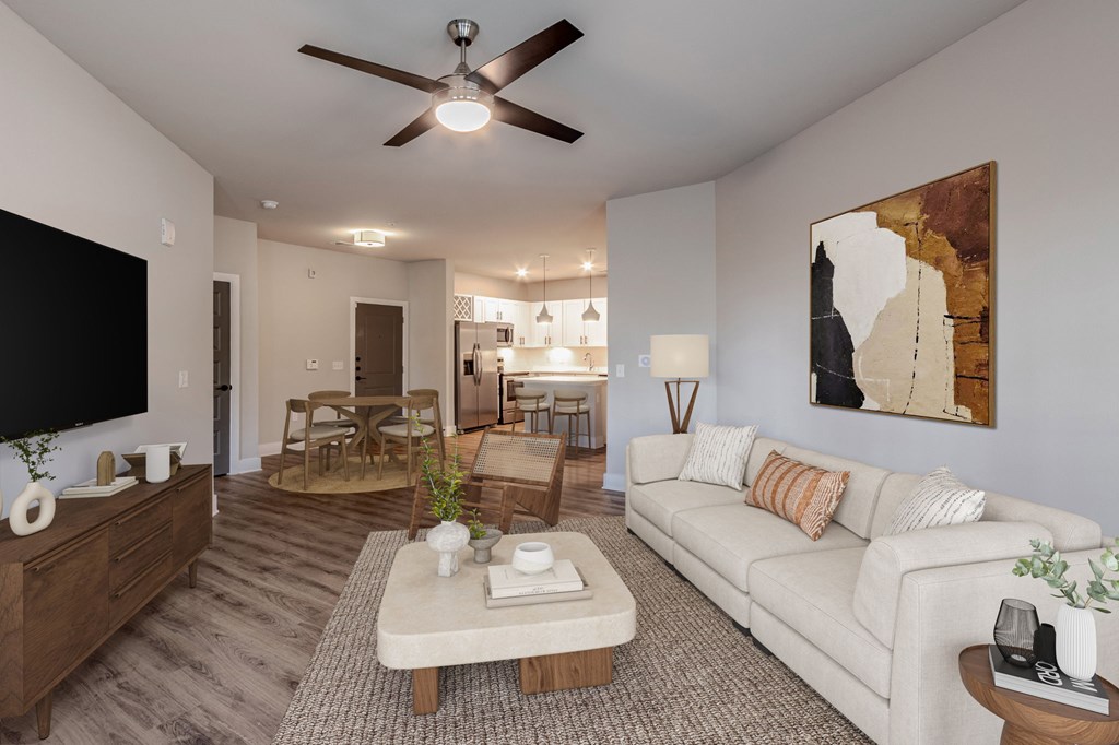 A living room with a white couch and a ceiling fan.