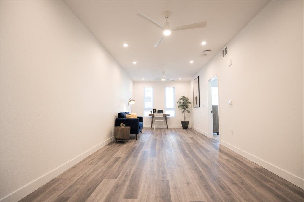 a flex space with a hardwood floor and white walls