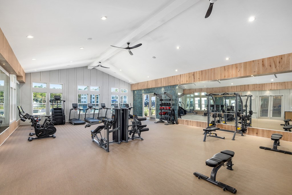 the gym has a large glass walled area with weights and cardio equipment