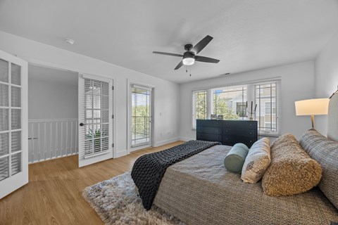 Asheville, NC, Apartments Near UNC Asheville - Verde Vista - Bright Bedroom With Ceiling Fan, Large Windows, Private Balcony Door, Wood Style Flooring, And French Door Entry.