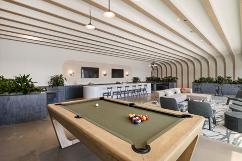 7th floor entertainment space with large island, ample seating, billiards table and views of the grill deck.