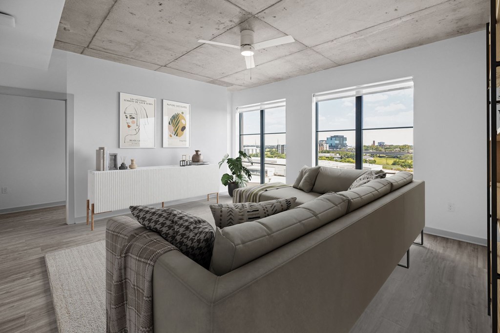 a living room with white walls and a concrete ceiling