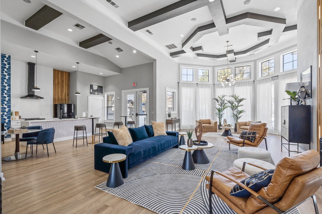 contemporary clubhouse with a kitchen island and gathering spaces at Bardin Greene apartments for rent in Arlington, TX.