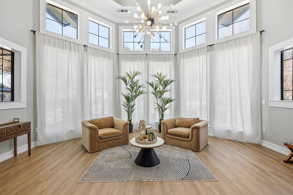 the living room of a house with two chairs and a table