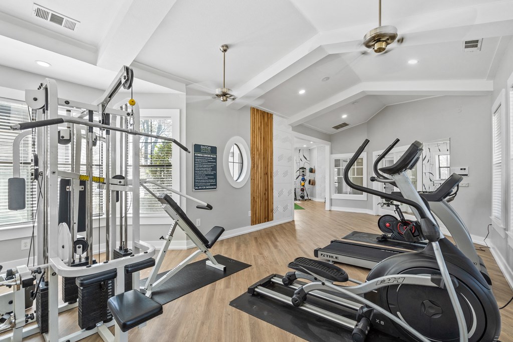two treadmills and other exercise equipment in a home gym