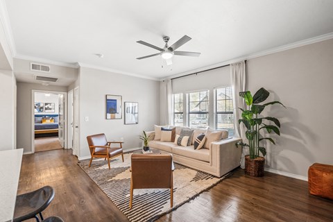 a living room with a couch and a ceiling fan