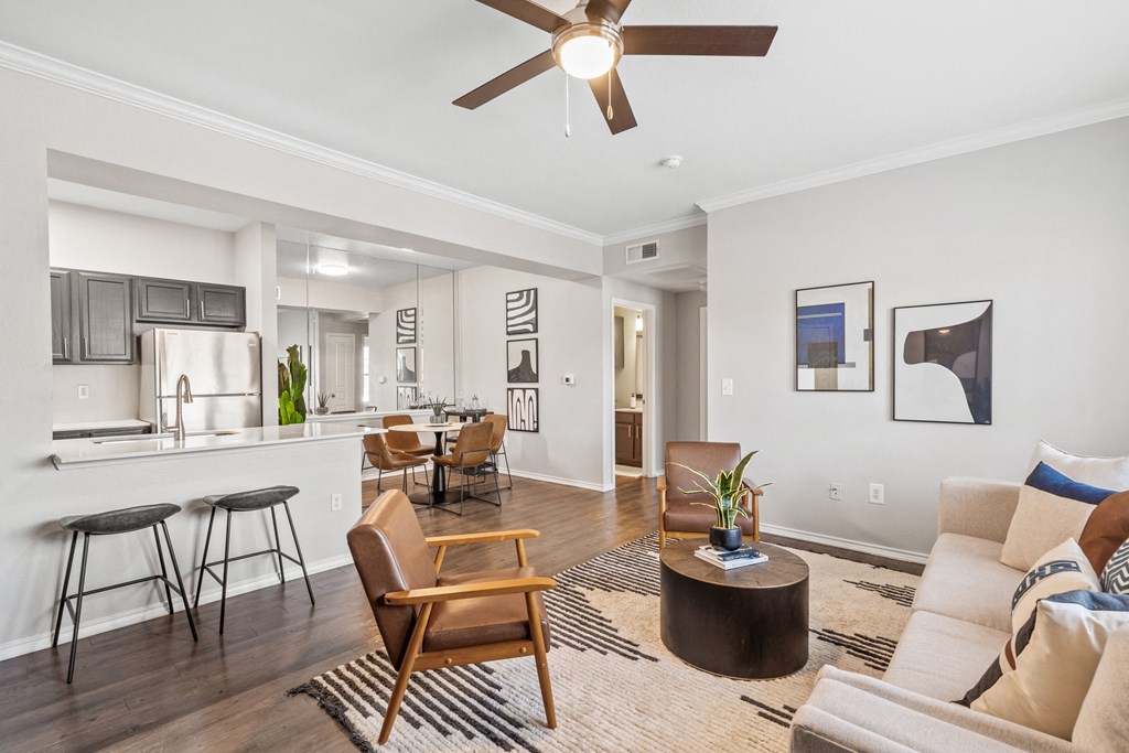 an open living room and kitchen with a ceiling fan