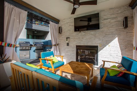 A living room with a fireplace and a balcony.
