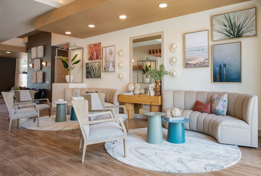 a living room with couches and chairs and a rug