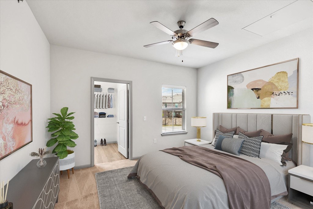 a bedroom with a large bed and a ceiling fan