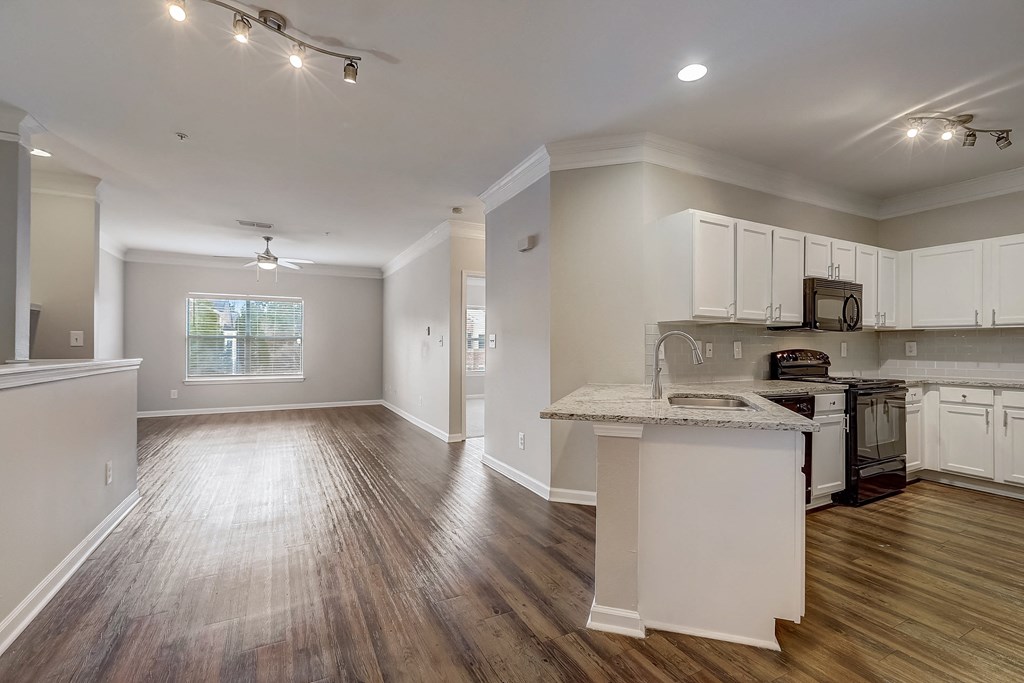 a kitchen and living room with hardwood floors