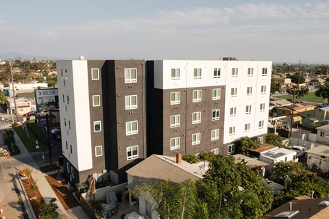 an aerial view of an apartment building with a black and white facade