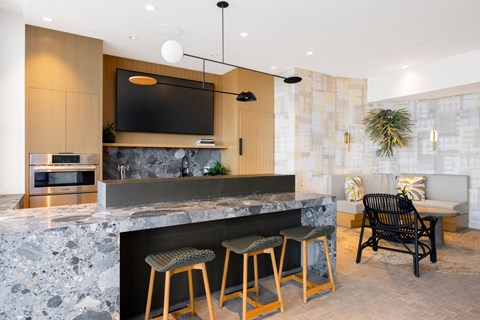 a kitchen with a marble counter top and stools