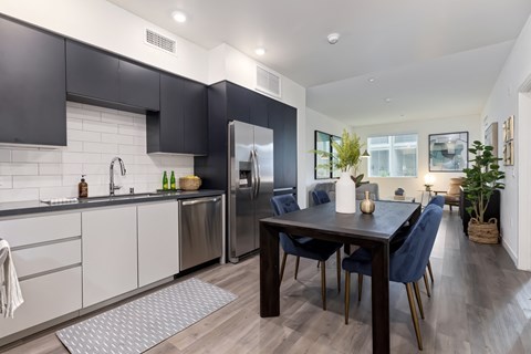 an open kitchen and dining area with a table and chairs