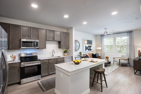 an open kitchen and living room with a large island and a