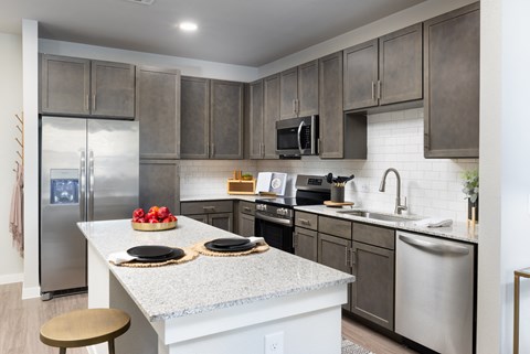a kitchen with stainless steel appliances and granite counter tops