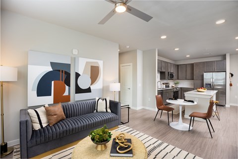 an open living room and kitchen with a couch and a table