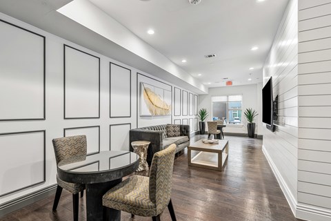 A modern dining room with a glass table and chairs.