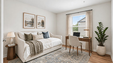 A cozy bedroom with a bed, desk, and chair.