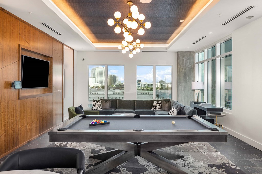 a living room with a pool table and a television