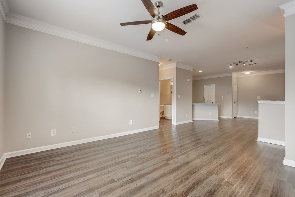a bedroom with a ceiling fan and hardwood floors