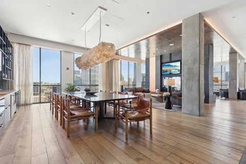 A modern dining room with a wooden table and chairs.
