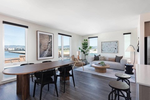 A modern living room with a large table and chairs.