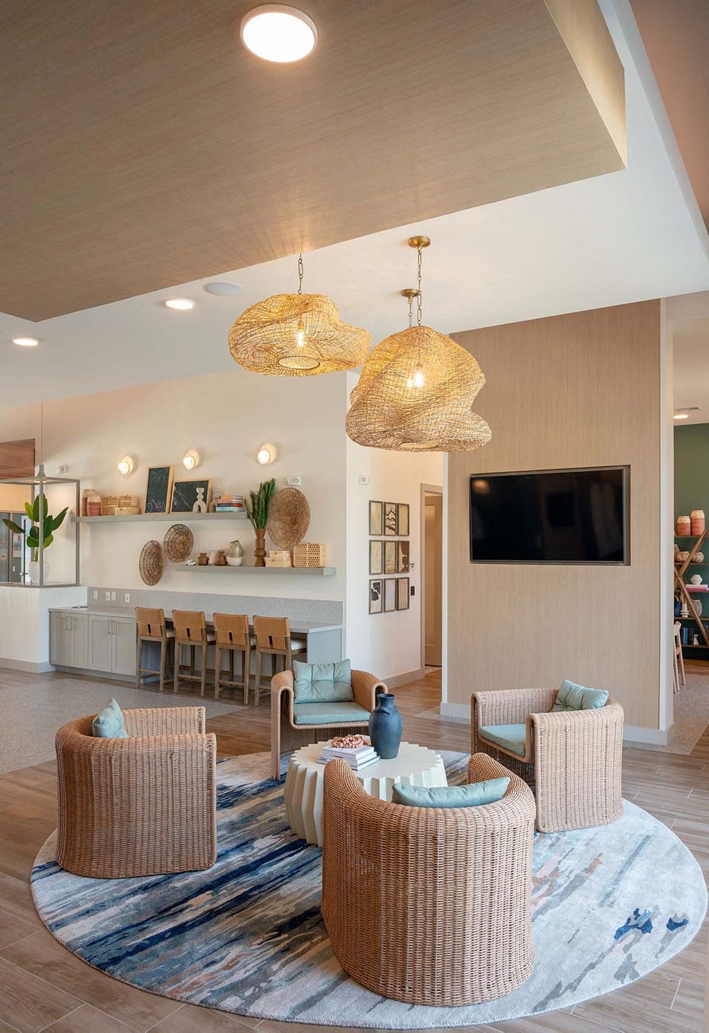 a living room with chairs and a table and a television