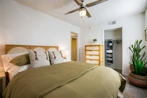 a bedroom with a bed and a ceiling fan