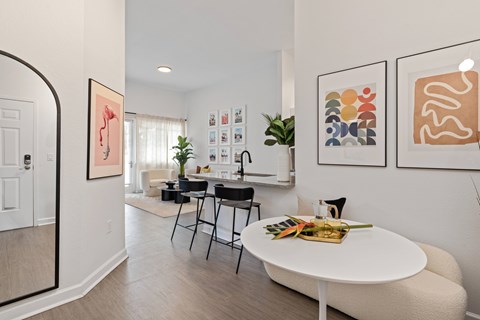 A white dining table with a tray of vegetables on it.