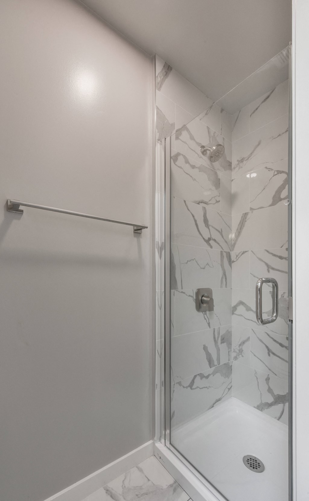 a small bathroom with a shower and a sink