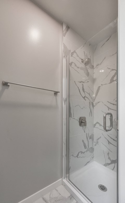 a small bathroom with a shower and a sink